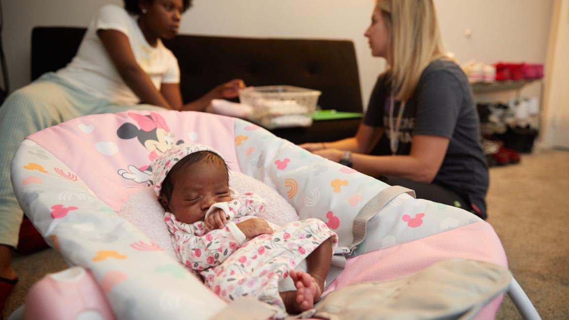 Photo of nurse working with family